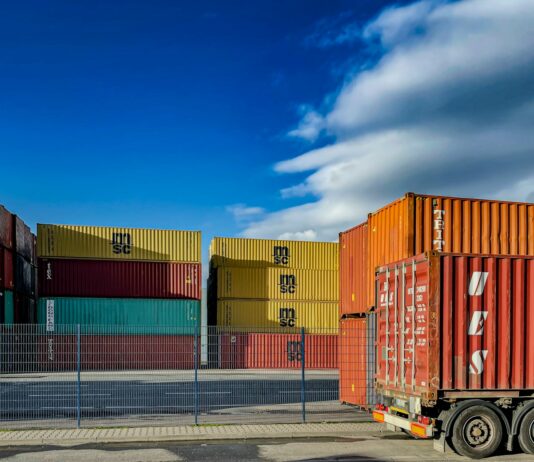 상반기 자동차 수출 370억 달러…사상 최고 실적 경신 a truck is parked in front of a bunch of shipping containers