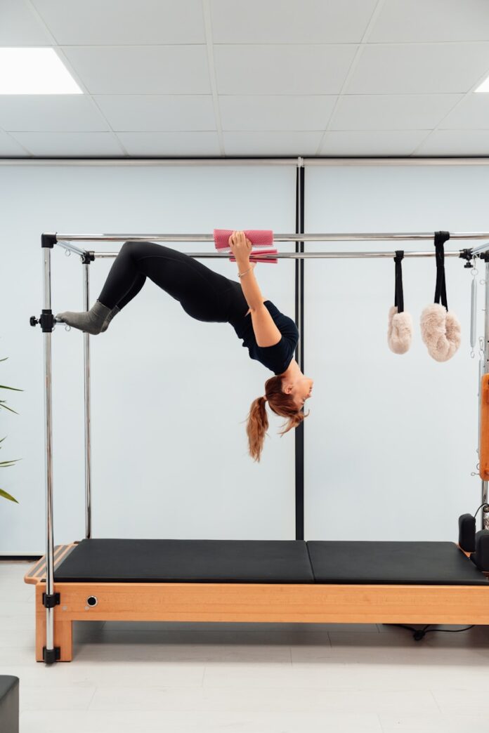 a woman doing a handstand on a pivot exercise