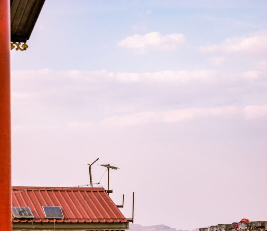 고독사 예방 안전망 가동 A man standing in front of a building with a red door