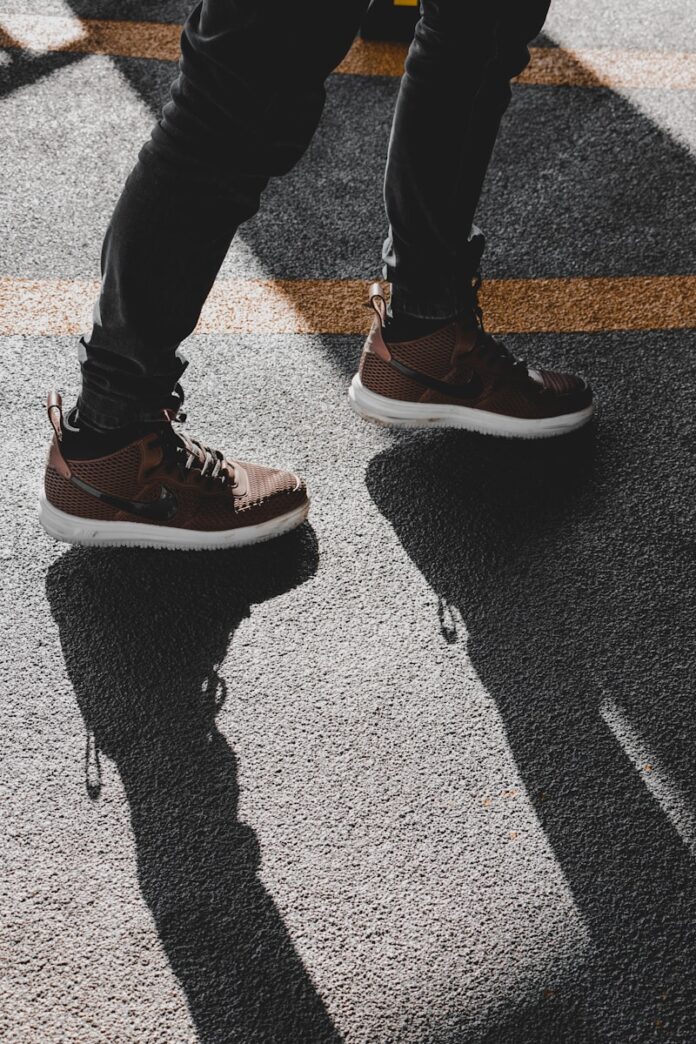 Photo by Amir Hosseini person wearing black and white nike sneakers