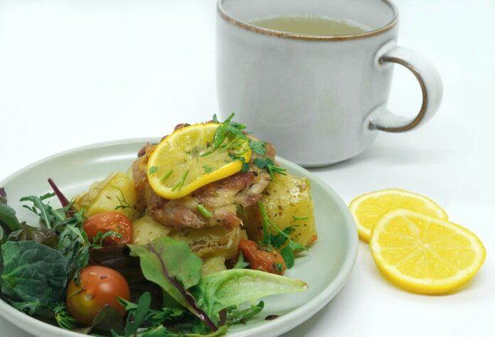 a plate of food next to a cup of tea